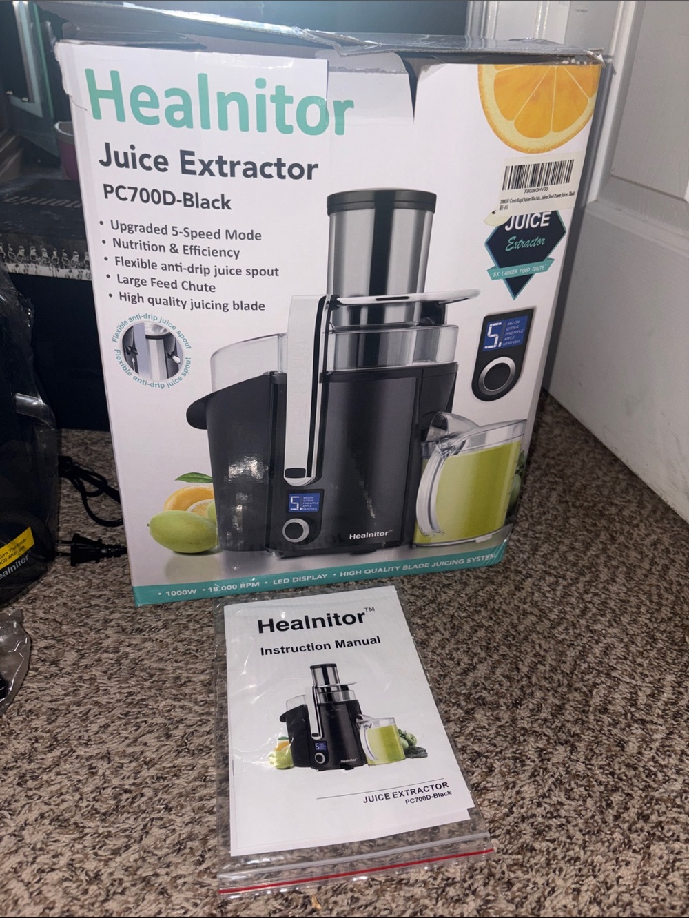 Black Healnitor Juice Extractor with Clear Hopper and Silver Accents